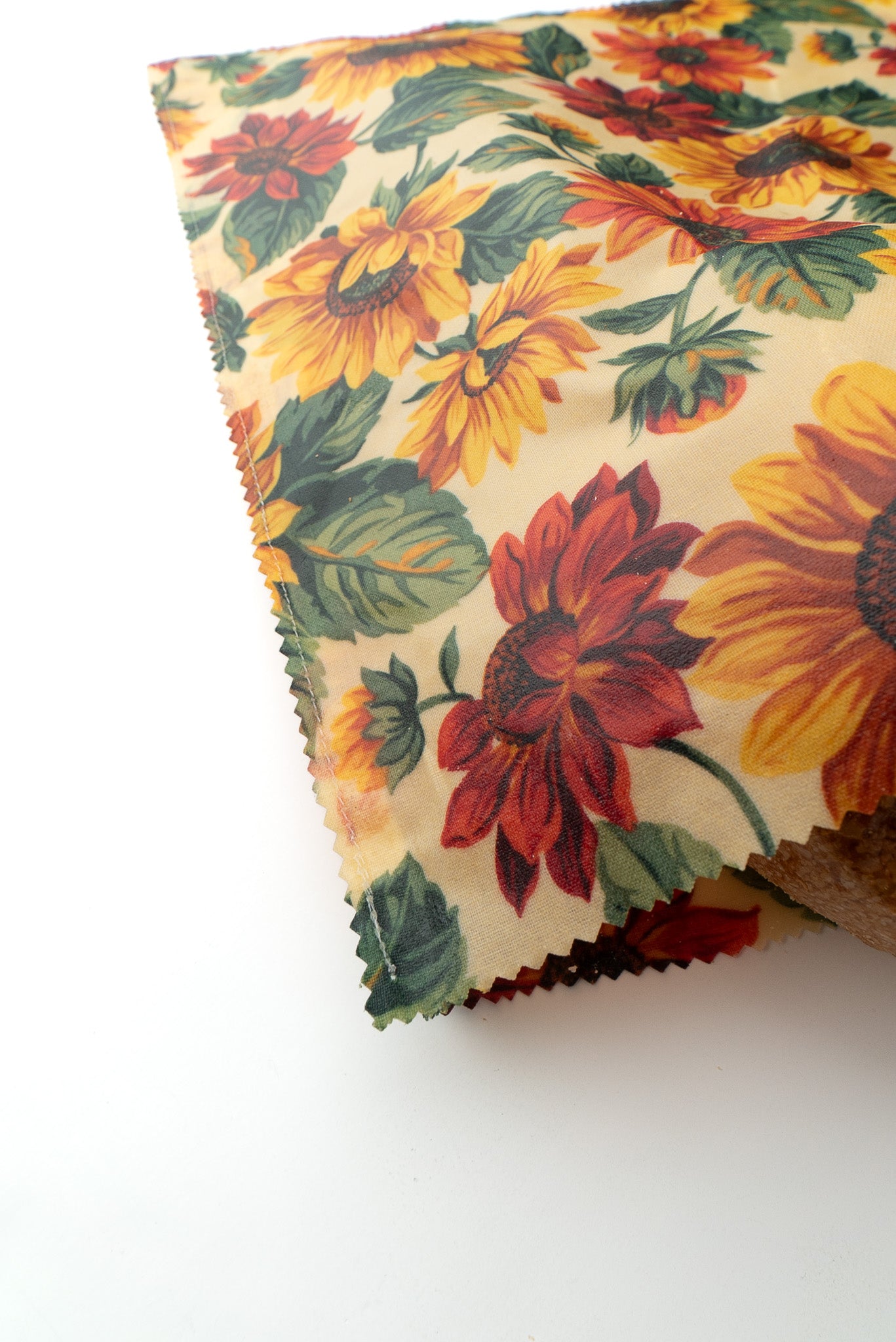Floral-patterned fabric with sunflowers on a white background