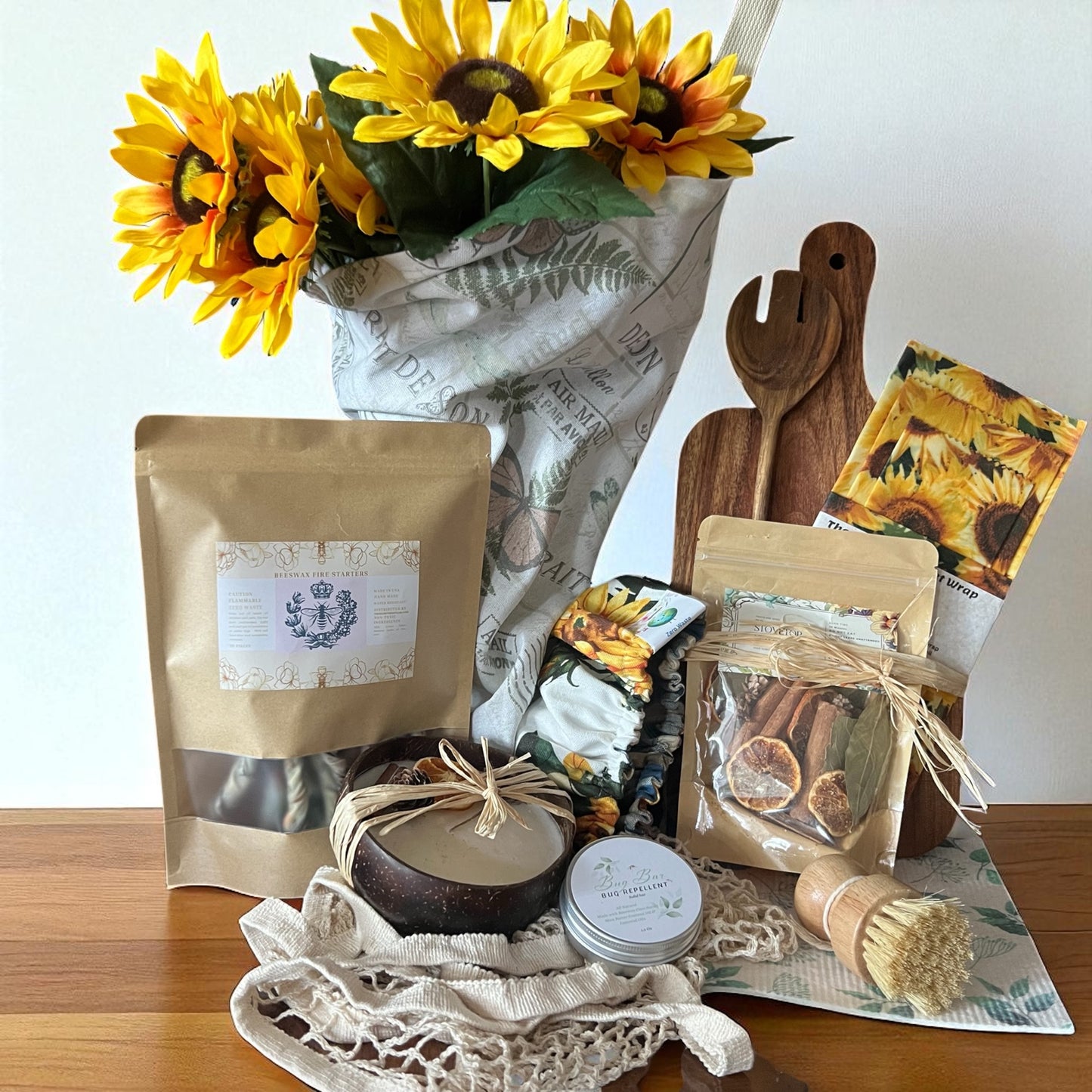 Gourmet gift set with sunflower-themed packaging on a wooden surface